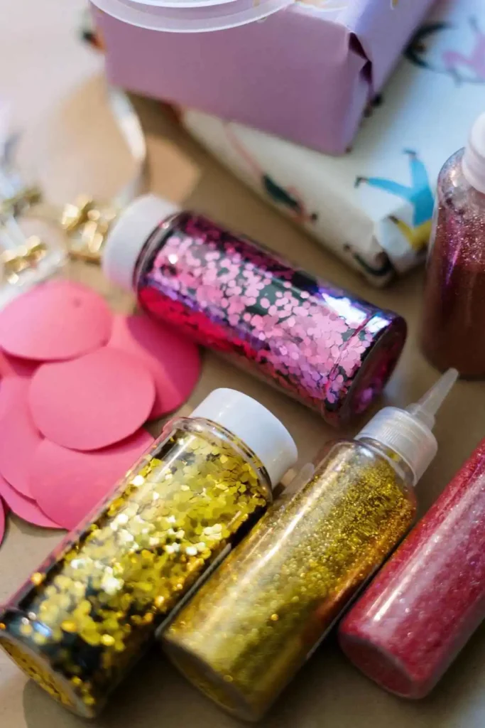DIY glitter water sensory bottle made with clear plastic bottle, water, glitter, and optional glue, designed as a calming sensory activity for toddlers and preschoolers