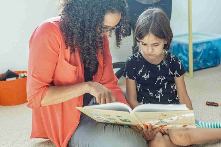 Mom and preschooler reading a picture book together before back to school