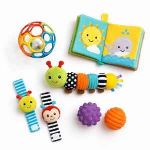 Best toys for 3 month old baby flat lay including rattle OBall activity book and sensory caterpillar on white background
