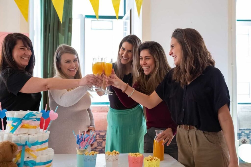 Adults competing in a diaper relay race at a coed baby shower party