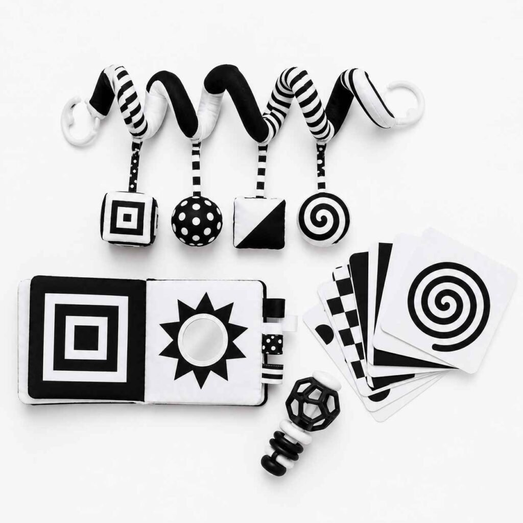 Joyreal high contrast baby toy bundle showing black and white car seat toy soft book rattle and flash cards on white surface for newborn visual stimulation
