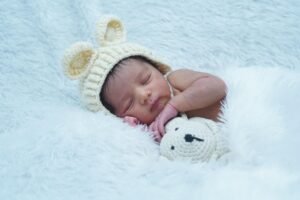 Overhead DIY newborn photo of sleeping baby on bed