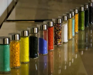 DIY sensory bottles for toddlers with glitter, oil, water, and colorful fillers in clear plastic bottles for calming play and development