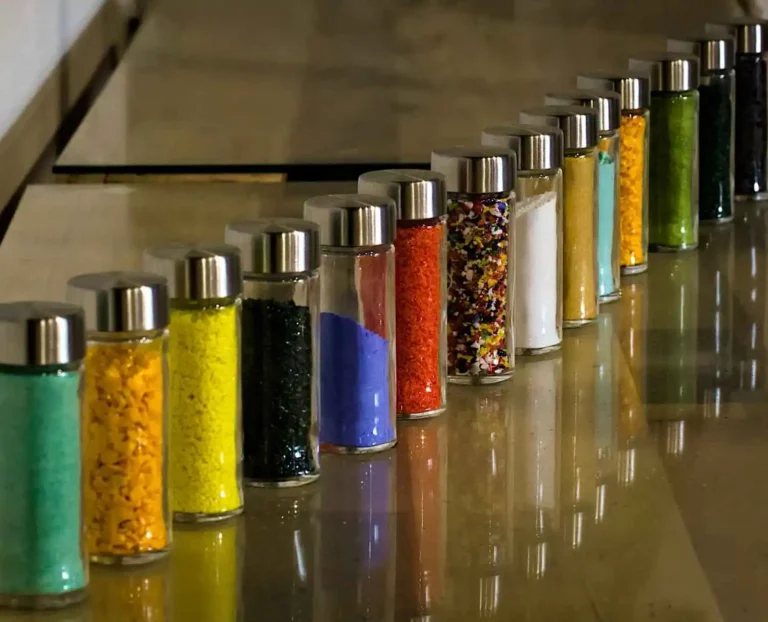DIY sensory bottles for toddlers with glitter, oil, water, and colorful fillers in clear plastic bottles for calming play and development