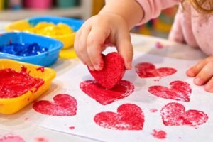 cutting kitchen sponges into heart star circle shapes for toddler stamping daycare craft ages 1-3